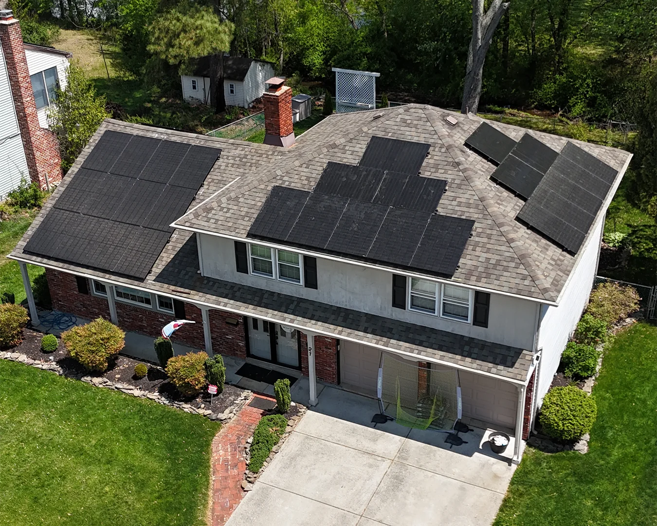 Aerial view of a house with solar panels on the roof